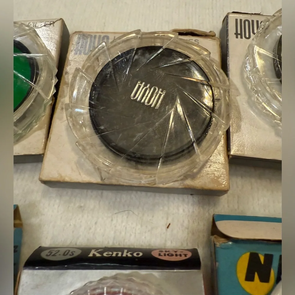 Lot of 4 Hoya photographic filters and 4 filter cases.